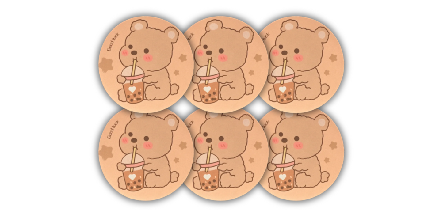 Boba Bear Coaster 6-Pack, featuring cute light brown bears with pink cheeks, each enjoying a cup of boba. Perfect for adding a fun and playful touch to your home or office.
