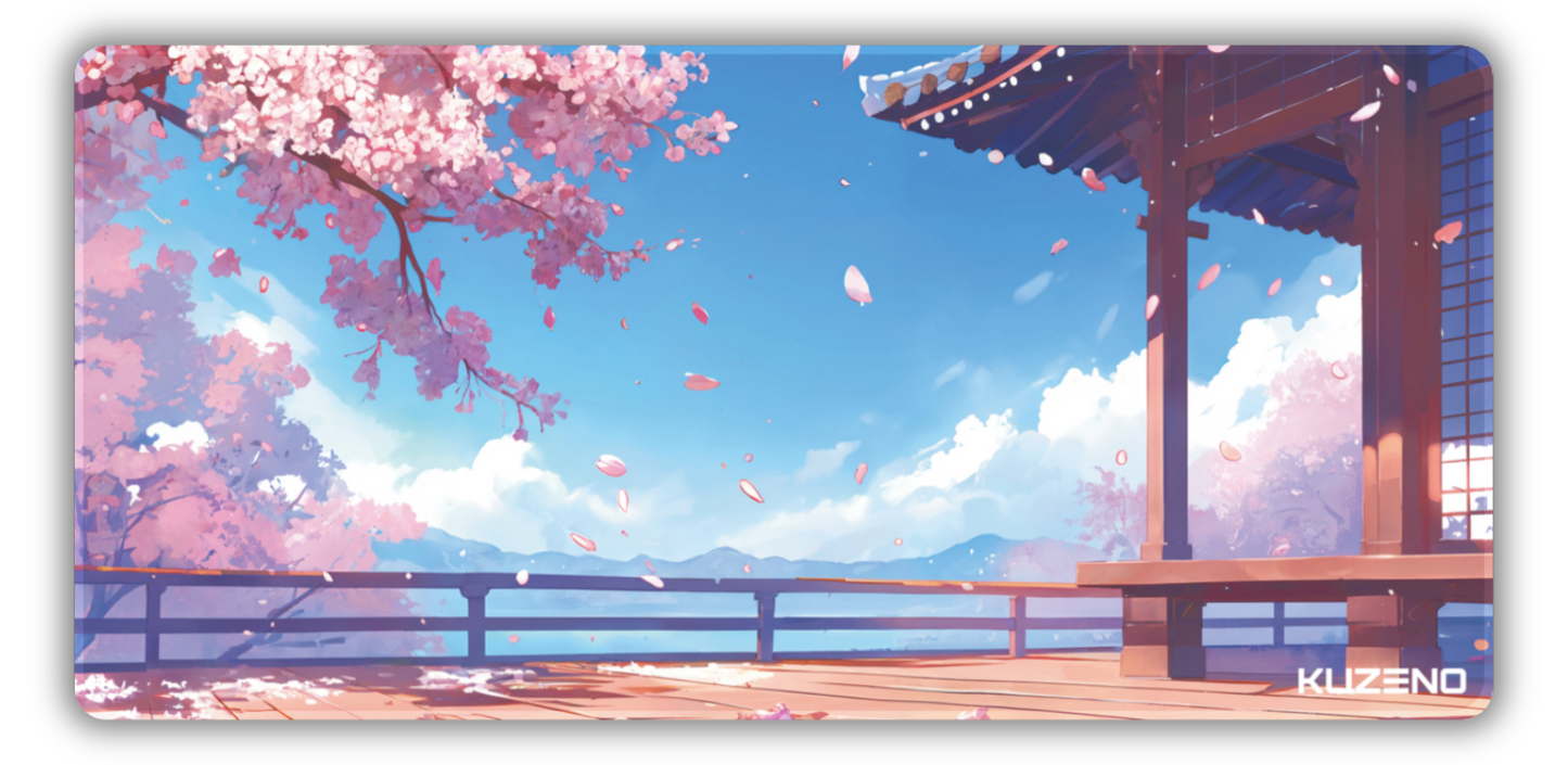 Sakura Skies gaming mousepad featuring blooming cherry blossoms, a traditional pagoda, and serene mountains beneath a clear sky, creating a peaceful and calming atmosphere.